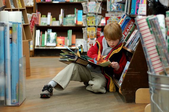 A child reading in Brookline Booksmith, an independent bookstore in Boston, Massachusetts. 
